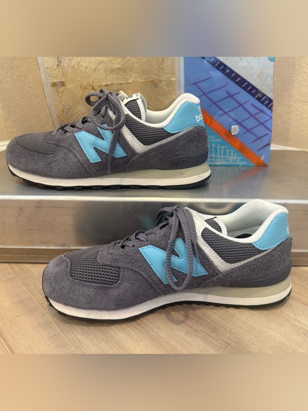 New Balance Mens 574 Gray Suede Sneakers with Light Blue Accents